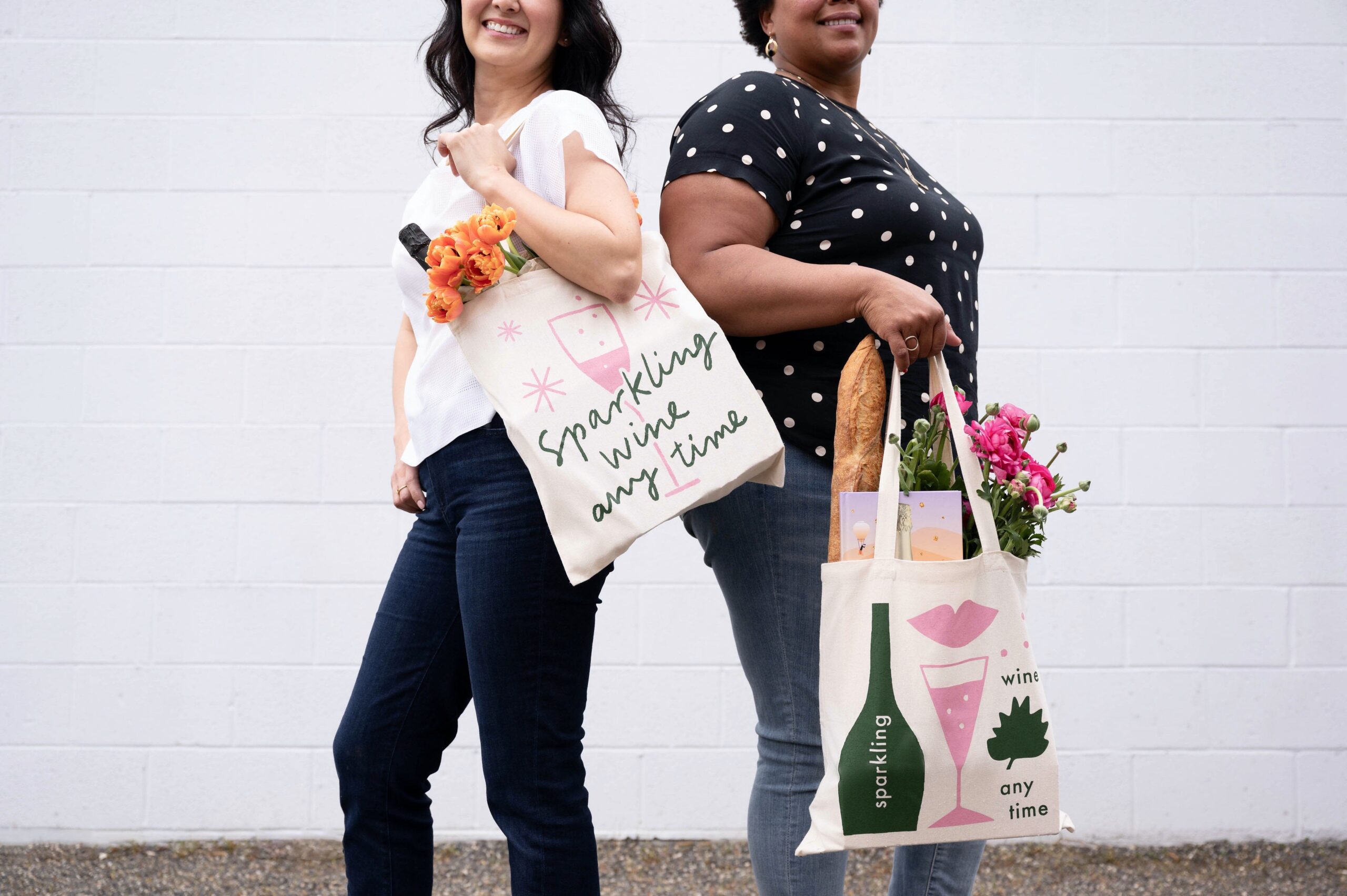 two women holding tote bags