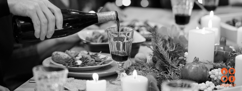 pouring wine at holiday dinner